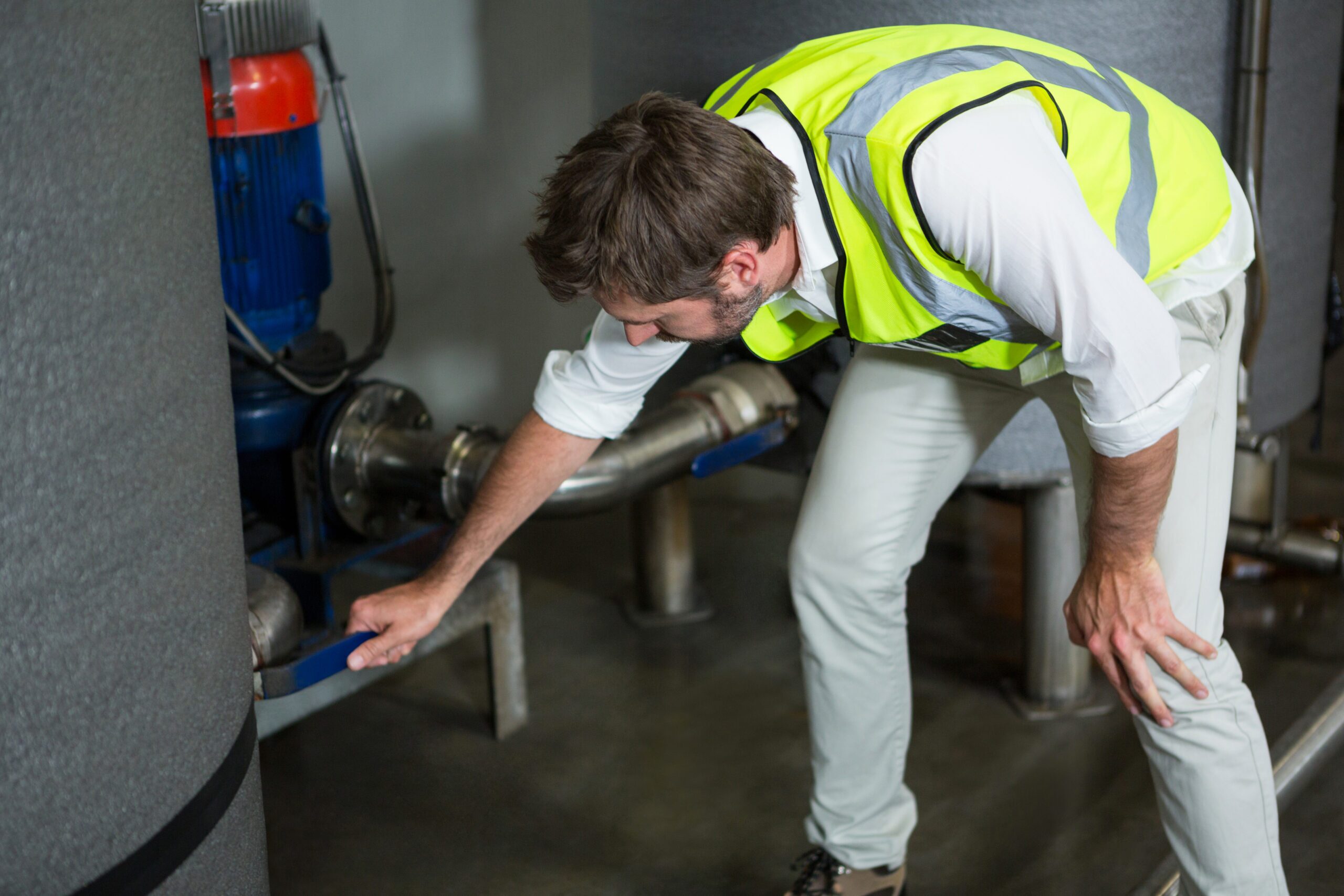 Technician operating pipe repair equipment